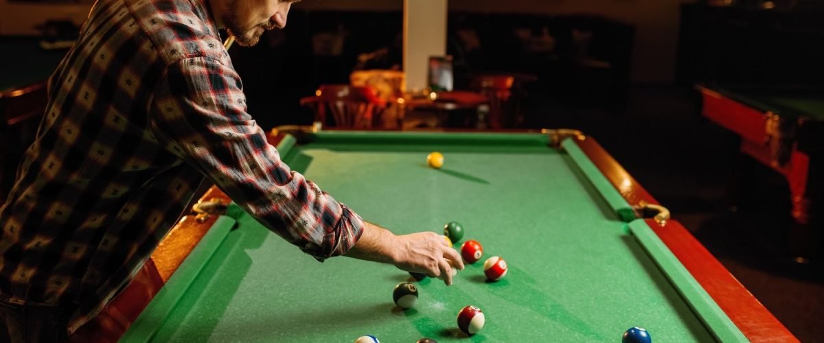 male-billiard-player-places-balls-poolroom-2021-08-26-16-27-00-utc-min.jpg